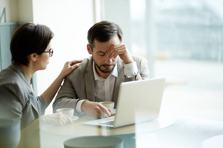 A person comforting a stressed out coworker.