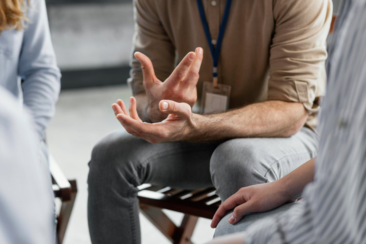 A picture of a person sitting in a therapy session.