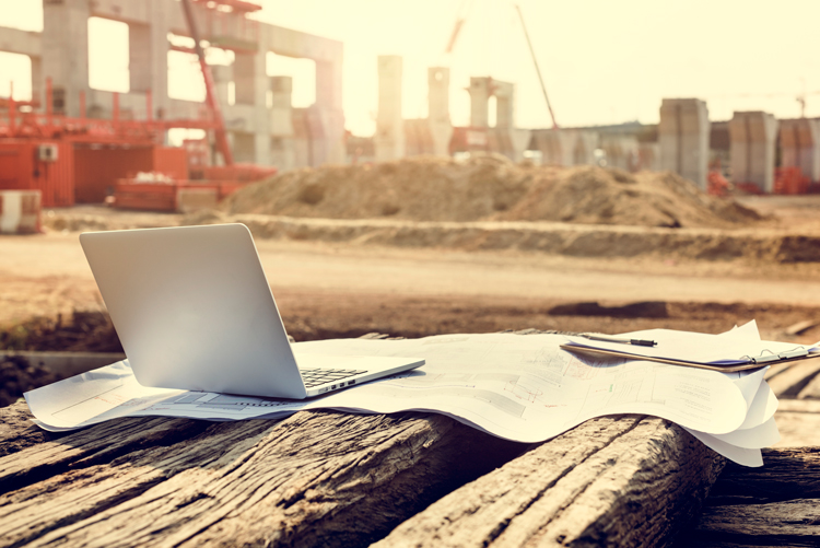 A laptop on a construction site representing the power of APIs