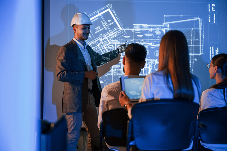 Presenter looking at blue prints